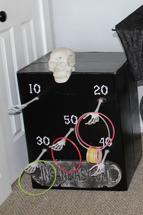 Michael’s Halloween Crafts, Diy Cardboard Halloween Games, Halloween Trick Or Treat Ideas At Home, Skeleton Ring Toss, Carnevil Halloween Party Games, Skull Toss Carnival Game, Kids Halloween Carnival Games, Kid Games For Halloween Party, Cardboard Box Halloween Decorations