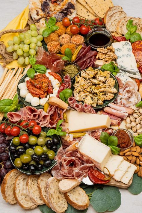 Dreaming of an authentic Italian dining experience at home? Our latest blog post guides you step by step to create the ultimate Italian Antipasto Platter - a vibrant feast for both the eyes and palate! From selecting the finest cheeses and cured meats to pairing with the perfect wine.🍷🧀 Plus, tips on arranging your platter to impress! Check out the full post for all the delicious details and elevate your next meal to a culinary adventure. #ItalianCuisine #AntipastoPlatter Italian Family Dinner Aesthetic, Italian Party Games, Italian Catering Ideas, Antipasta Platters Italian, Antipasto Platter Ideas, Italian Antipasto Platter, Hosting Food, Italian Platter, Italian Food Party