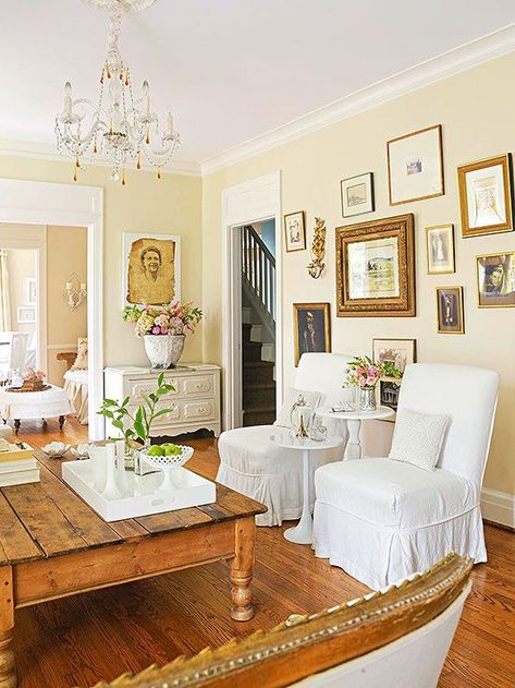 Antique Color Scheme  Tea-Stain + Gold + White. Love the wooden floors and antique gallery wall Pale Yellow Walls, Light Yellow Walls, Yellow Walls Living Room, White Slipcovers, Yellow Colour Scheme, Yellow Room, Yellow Living Room, Gold Frames, Yellow Bedroom