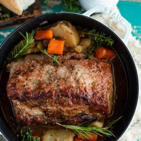 Tender and juicy, this Dutch Oven Pork Roast transforms an affordable cut of meat into a delicious comfort food dinner. The pork loin slowly bakes in an apple cider broth with potatoes, carrots, celery, onion and herbs. A quick pan gravy adds the perfect finishing touch on the one pot meal. Serve this simple boneless pork roast recipe with a side of flaky buttermilk biscuits or a pan of cornbread for your next cozy Sunday supper! Dutch Oven Pork Roast, Oven Pork Roast, Roast In Dutch Oven, Dutch Oven Pork, Pork Roast With Gravy, Boneless Pork Loin Recipes, Pork Pot Roast, Roast With Gravy, Boneless Pork Loin Roast