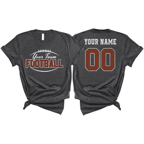 PRICES MAY VARY. PERSONALIZED T-SHIRT: A personalized Football T-shirt with name and shirt number will be the perfect gift for football lovers, mom, daughter, sister, niece, Wife, girlfriend,... Click on "Customize Now" and and start designing your unique shirt. MATERIAL: Solid colors are 100% cotton ( Black, White, Navy , Forest Green). Dark Heather colors are 50% cotton, 50% polyester. Sport Grey and Athletic Heather 90% cotton, 10% polyester. Color Dark Gray Heather and Heather Mauve 52% cott Saints Football Shirts, Football Rivalry Shirts, You Better Hit Somebody Football Shirt, Senior Football Mom Shirts 2025, Flag Football Shirts Design, Football Diy Shirts, Football Fan Shirts High School, Cute Football Shirts Ideas, Aunt Football Shirt Ideas