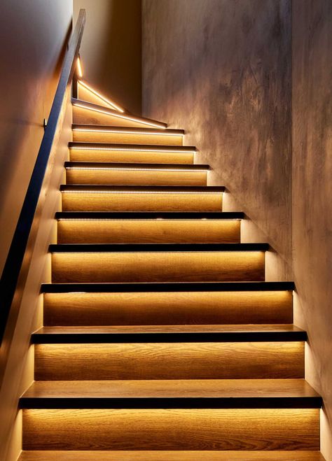 In a close-up look at these modern stairs, you can see the hidden LED lighting strips that are located underneath the tread, and highlight the stair riser. Stair Tread Lighting, Under Stair Lighting, Closed Staircase Ideas, Closed Staircase, Stairway Ideas, Stairs Lighting, Rustic Stairs, Hidden Lighting, A Modern House