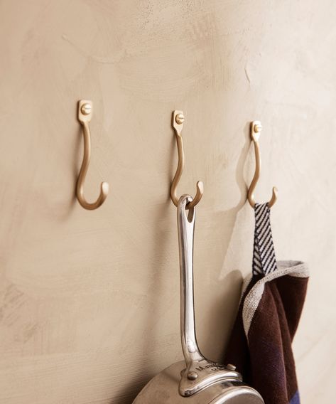 Curvature is a series of organically shaped accessories for the home that have been hand formed in pure, solid brass with a matte finish. The whimsical curves juxtapose the solidity of the material and make a feminine, functional addition to any bedroom, bathroom, hallway or kitchen. The Curvature Mini Hooks are an ornamental yet elegantly simple hook, perfect for hanging up your everyday essentials. Crafted by hand, no two hooks are 100% identical. Designed and produced by the Copenhagen-based Home Must Haves, Austin House, Ski Condo, Brass Coat Hooks, Brass Wall Hook, Basement Reno, Wall Mounted Hooks, Deco Nature, Bathroom Hallway