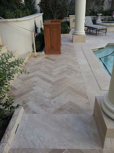 poolside travertine in herringbone pattern Pool Travertine Pavers, Herringbone Garden Paving, Herringbone Outdoor Tiles, Pool Patio Flooring Ideas, Travertine Herringbone Tile Floor, Herringbone Pool Deck, Herringbone Travertine Floor, Travertine Outdoor Patio, Travertine Porch