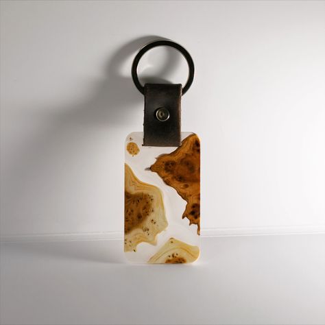 A keychain made from both resin and wood is a unique and eye-catching accessory that is perfect for anyone who wants to add a touch of style and personality to their keys. Combining resin and wood creates a stunning contrast of materials with the colorful and glossy resin and the natural and rich texture of wood. Wood And Resin Keychain, Handmade Amber Necklaces With Resin, Handmade Amber Resin Necklace, Amber Resin Pendant Necklace, Keychain Resin, Wood Resin Necklace, Motel Keychain, Wood Keychain, Car Keychain