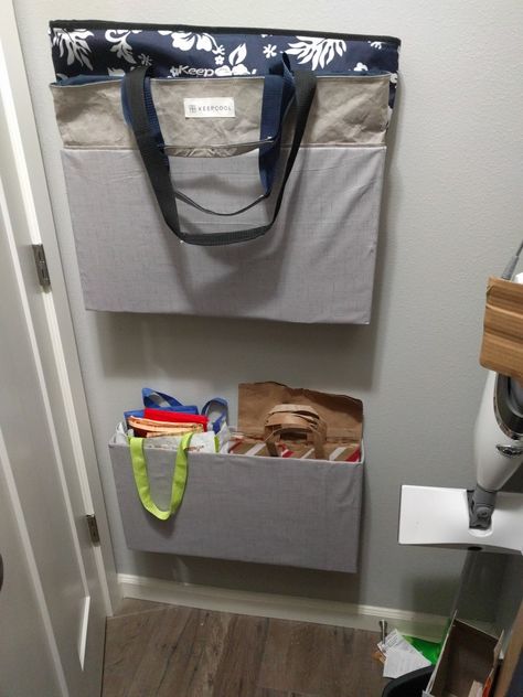 I taped together cardboard to create boxes then hot glued fabric to outside, I used command hooks to stick on wall, no more reusable bags everywhere and it was free for me. Reuseable Bag Storage Ideas, Storage For Reusable Shopping Bags, Storing Reusable Shopping Bags, Organize Reusable Bags, Reusable Grocery Bags Storage Ideas, Reusable Bag Storage Ideas, Reusable Bag Storage, Reusable Grocery Bags Storage, Entry Closet Ideas