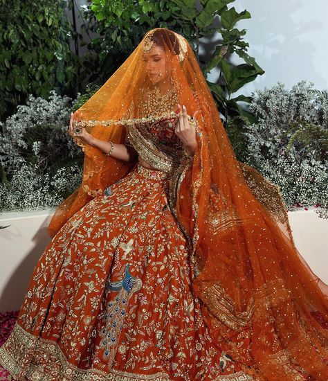 Get ready to be amazed by this stunning burnt orange bridal joda! Inspired by the beauty of lotus flowers and the magnificent peacock, this outfit is a masterpiece of intricate detailing and vibrant colours. The flying peacock motifs not only bring an element of positivity but also exude elegance. Complete with a graceful veil and a border dupatta, this ensemble is a true embodiment of grace and beauty. Style by @devampandeyofficial Jewellery @rang.mahal.jewels White Lehenga With Green Dupatta, Orange Wedding Lehenga Indian Bridal, Orange Lehenga Bridal, Orange Wedding Lehenga, Burnt Orange Lehenga, Orange Bridal Lehenga, Flying Peacock, Dupatta Setting, Bridal Anarkali