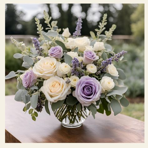 Deepest Sympathies Floral Arrangement Description: Express your heartfelt condolences with our exquisite "Deepest Sympathies Floral Arrangement." This thoughtfully curated bouquet combines the timeless elegance of lavender and white roses, creating a serene and comforting display that conveys your deepest sympathies. Standard: A fuller bouquet for those who want a bit more floral beauty: 12" L x 12" W x 16" H Traditional Elegance: A statement piece that’s sure to impress: 14" L x 14" W x 20" H E Purple And White Flower Arrangements Centerpieces, Sterling Roses Bouquet, Lavender Hydrangea Centerpiece, Simple Purple Flower Arrangements, Lavender Wedding Arrangements, Lavender And White Centerpieces, Lavender And White Flower Arrangements, Wedding Flowers Purple Lavender, Fresh Floral Centerpieces