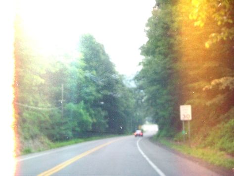 Blurry view from inside a car onlooking into the road ahead with a car in the distance and trees surrounding the road. Light leaks on both sides and a 30 mph sign to the right. Emo Midwest, Midwest Emo Summer, Midwest Emo Clothes, Midwestern Emo Aesthetic, Emo Summer, Midwestern Emo, Midwest Core, Midwest Aesthetic, Midwest Emo Fashion