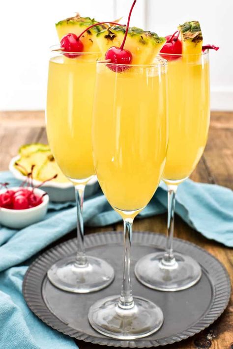 Pineapple Upside Down Mimosas are one of our favorite brunch time beverages! They combine the classic mimosa you know and love with the delicious taste of pineapple upside down cake. Made with just 3 simple ingredients, these drinks are easy to prepare and perfect for any occasion. Make your next brunch extra special with these extra special (extra yummy!) mimosas! Pineapple Upside Down Mimosa, Mimosa Ideas, Functioning Alcoholic, Classic Mimosa, Lemon Tree Dwelling, Cake Vodka, Champagne Punch, Tropical Drinks, Mimosa Recipe