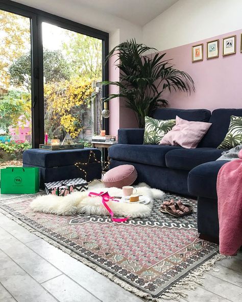 Blue velvet sofa, french connection rug, pink walls, bifold doors and plants in this very fresh and contemporary living room #livingroom #livingroomdecor Blue Velvet Couch With Pink Armchair, Navy Sofa Pink Walls, Navy And Pink Rug Living Room, Blue Walls Pink Sofa, Blue Sofa Pink Wall, French Connection Rug, Navy Sofa Living Room, Blue And Pink Living Room, Blue Velvet Sofa Living Room