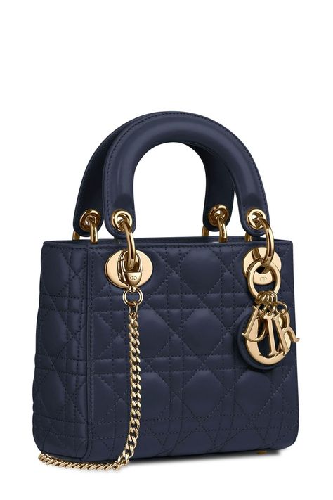 DELICATE Treat it gently and with extra care. This chic tote is crafted of stuffed geometric quilted lambskin leather in dark navy. The bag features reinforced leather top handles and gold Dior letters charm. The top zipper opens to a jacquard fabric interior for everyday essentials and the classic chic of Christian Dior! Classic Handbags Designer, Chanel Kelly, Famous Clothes, Random Wishlist, Chanel Mini Rectangular, Chanel Mini Square, Christian Dior Bag, Luxury Bags Collection, Chanel Mini