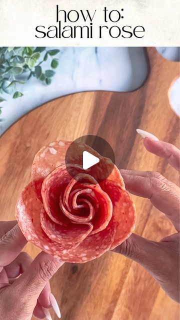 Kim Charon | Charcuterie & Things LLC on Instagram: "DIY: SALAMI ROSES 🌹 

Tools: 2oz condiment cup and 11 salami slices

Layer: Place 5 slices halfway over the first one around the cup. 

Create the bud: Fold 6 slices of salami in half with the rounded side up. Layer the folded slices on top of the other right to left. 

Roll: Start rolling from one end to the other, securing the base as you go.

Finish: Gently spread the “petals” to create a rose shape.

PRO TIP: Mix and match different types of salami for added texture and flavor. 🌟

SAVE and FOLLOW @charcuterie_n_things for more cheese and charcuterie food styling tips!

#charcuterie #foodstyling #cheese #grazingtable #partyplanning #fooddesign #longisland #fyp #charcuterieandthings #easyappetizers #quickandeasy #CheeseBoard #Charcut Charcuterie Board Ideas Salami Rose, Cheese Slices Charcuterie, How To Fold Meet For Charcuterie, Prosciutto Rose How To, Cheese Flowers Charcuterie, Rose Salami Charcuterie, Folding Salami, Salami Flower Charcuterie, Folding Salami For Charcuterie