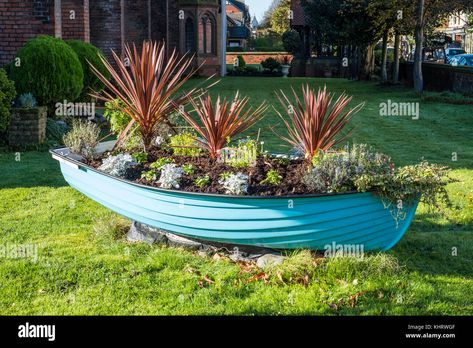 Download this stock image: A lovely old rowing boat used as a planter and garden feature. - KHRWGF from Alamy's library of millions of high resolution stock photos, illustrations and vectors. Boat Planter, Boat Garden, Planter Diy, Seaside Garden, Rowing Boat, Floating Garden, Boat Ideas, Master Ensuite, Stone Planters