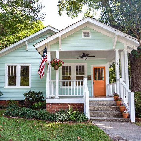 Exterior House Colors Bright, Light Blue Bungalow Exterior, Orange Front Door Blue House, Light Orange House Exterior, Bright Colored Houses Exterior, Light Orange Front Door, Light Blue House Front Door Color, Mint House Exterior, Coral House Exterior