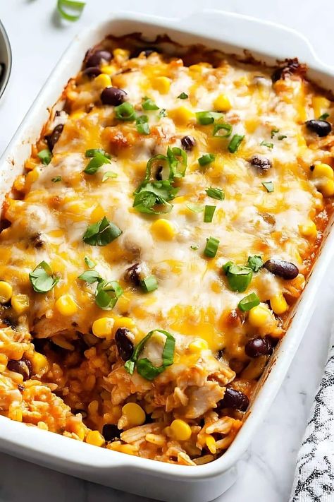 This Southwest chicken casserole is easy, cheesy, and delicious! It's full of tender chicken, rice, beans, corn, plus gooey cheese and yummy toppings. Couscous Casserole, Rice Beans Corn, Southwest Chicken Casserole, Southwest Chicken And Rice, Chicken Rice Beans, Casseroles Chicken, Southwest Egg Rolls, Easy Casseroles, Southwest Recipes