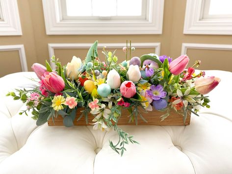 "This Adorable Easter Spring Flower Centerpiece will bring the spring season right into your home. Only one available. Arranged in a rectangle wood box, this design contains Easter gnome and chick with eggs tucked away in bursts of beautiful  spring flowers and greenery. Whether you place it on the dinning table, side table, or foyer, it will surly bring the joy of the season.   The wood box is 13.75\"(L) x 4\"(W) x 2\"(H), and the finished design is about 19\"(L) x 10\"(W) x  8\"(H) All designs Easter Floral Arrangements, Flower Box Centerpiece, Beautiful Spring Flowers, Easter Floral Arrangement, Easter Arrangement, Tulips Arrangement, Easter Gnome, Flower Centerpiece, Arrangement Ideas