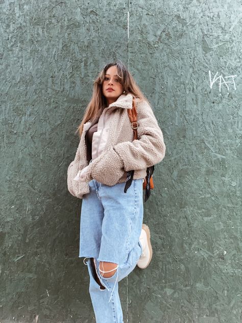 Woman with long hair leaning on green wall wearing Plush sherpa jacket + jeans + beige combat boots Beige Sherpa Jacket Outfit, Sherpa Jacket Outfit Women, Cropped Teddy Jacket Outfit, Boots Outfit Jeans, Beige Combat Boots, Teddy Jacket Outfit, Sherpa Jacket Outfit, Jackets Outfit, Jacket Outfit Women