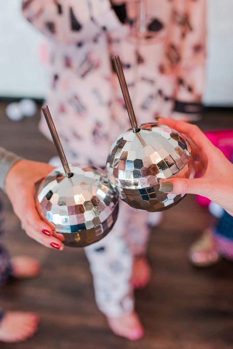 Have a little fun with your holiday cocktails and serve up a signature sip in an interesting glass, like these disco balls! The more festive, the better. #holidayparty #christmasparty #christmas #friendsmas #cocktails #bartender #signaturecocktail #partyfood #partydrinks Friendsmas Cocktails, Christmas Friendsmas, Disco Ball Glasses, Disco Ball New Year Party, Disco Ball Nye Decor, Disco Ball Cocktail, Holiday Party Cocktails, New Years Eve Party Ideas Theme Disco Ball, Disco Glasses