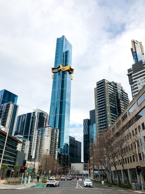 Busy and bustling street with massive golden sky scraper towering high above Australia Aesthetic Melbourne, Skyscraper Aesthetic, Melbourne Nature, Melbourne Night Aesthetic, Aesthetic Melbourne, Melbourne Aesthetic Cafe, City Aesthetic Melbourne, Melbourne Aesthetic, Melbourne Australia City