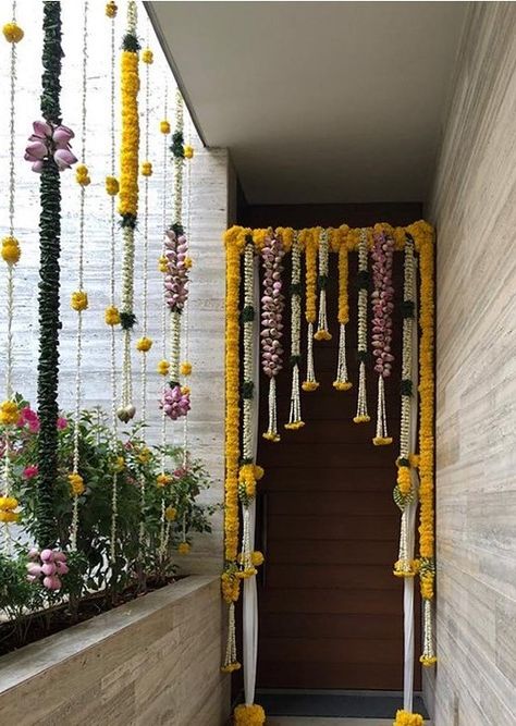 Delightful Floral entrance by Studio Reve Events- Chennai. #housewarmingceremony #housewarming #houseparty #housedecor #homedecor #entrancedecor #homeentrancedecor #houseceremony #entrance #floralentrance #traditionalentrance #entrancedecor #marigoldentrance #marigolddecor Floral Entrance, Door Flower Decoration, Hanging Floral Decor, Home Flower Decor, Diwali Decorations At Home, Wedding Background Decoration, Housewarming Decorations, Diy Diwali Decorations, Ganpati Decoration Design