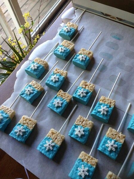 Frozen themed rice crispy treats Frozen Treats Disney, Frozen Themed Birthday Party Treats, Disney Frozen Themed Food, Frozen Themed Snacks For Kids, Frozen Party Treats Ideas, Frozen Disney Desserts, Frozen Candy Table Ideas, Frozen Themed Dessert Table, Frozen Themed Christmas Party