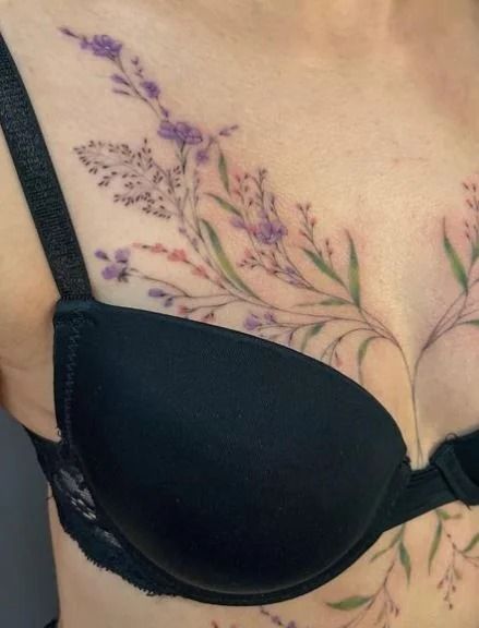 55+ Breast Tattoo Ideas To Define Your Femininity Breast Tattoos For Women Chest Piece, Breast Reduction Tattoo Cover Up, Upper Breast Tattoo For Women, Dainty Chest Tattoo Female, Under Breast Tattoos For Women, Under Breast Tattoos, Breast Tattoos For Women, Cleavage Tattoos, Flower Chest Tattoo