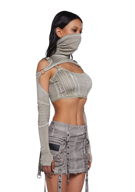 in stretch cotton jersey with an off white fabric finish. Adjustable shoulder straps, O-ring hardware, contrast stitching, turtle neckline, removable pintuck sleeves with thumbhole cuffs, a cropped fit, and embroidered “D” logo on the back. Dune Festival Outfit, Desert Rave Outfits, Dragon Outfit Aesthetic, Dune Rave Outfit, Rave Looks Outfit, Dune Inspired Outfit, Grunge Rave Outfits, Dune Outfit, Rave Inspo Outfits