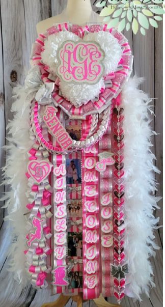 Barbie Mums Homecoming, Red And Black Mums Homecoming, Hot Pink Mums Homecoming, Senior Year Mums, Hoco Mums Ideas, Senior Festivities, Pink Homecoming Mum, Senior Painted Jeans, Hot Pink Homecoming