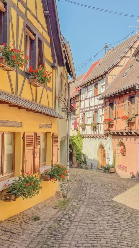 pastel streets of one of the most beautiful town in France to visit Eguisheim Europe Town Aesthetic, Town Reference Photo, Small French Town Aesthetic, Small Town France, Pastel Country Aesthetic, Cottagecore Town Aesthetic, City Landscape Reference, Small French Town, Cute Town Aesthetic