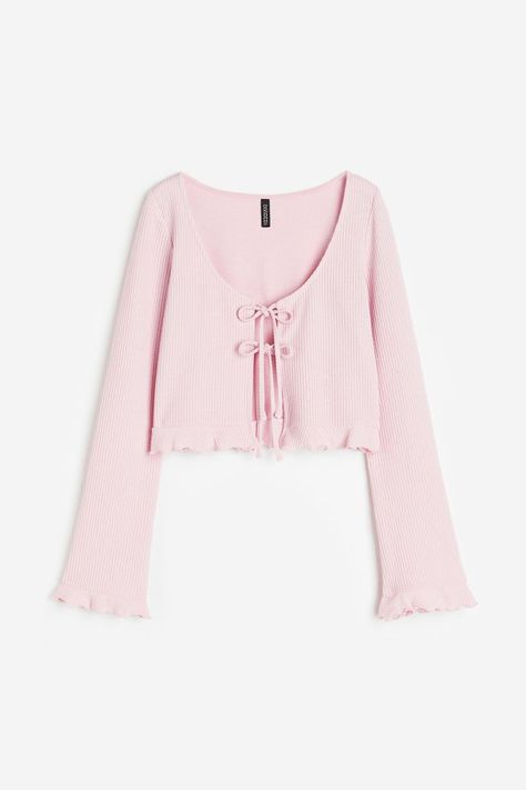 Cropped, fitted cardigan in ribbed jersey. Features a deep, round neckline and an open front with two pairs of narrow ties. Long sleeves and a small frill trim with an overlocked edge at the cuffs and... Pink Crop Cardigan, Bow Cardigan, Rib Cardigan, Dream Aesthetic, Crop Cardigan, Fitted Cardigan, Pink Cardigan, Ribbed Cardigan, Deep Neckline