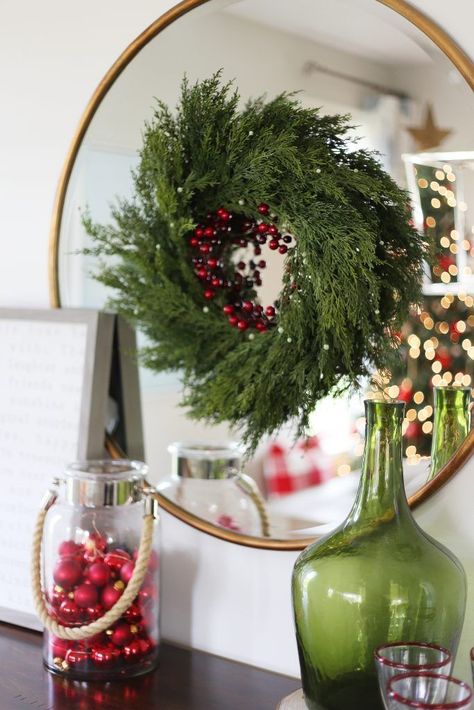 Christmas wreath in a holiday dining room. Love this hung directly over the mirror! Wreath On Round Mirror, Christmas Wreath On Mirror, Christmas Mirror Decor, Christmas Mirrors, Christmas Mirror Decorations, Wreath On Mirror, Holiday Dining Room, Christmas Mirror, Farmhouse Christmas Wreath