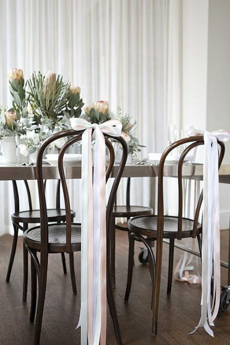 Brentwood chairs with simple but sophisticated narrow ribbon bows trailing to the floor. Source: My.Sweet.Love #chairdecor #weddingchair Wedding Guest Photo Backdrop, ขวดโหล Mason Jar, Simple Bridal Shower Decorations, Brunch Inspiration, Simple Bridal Shower, Chair Bows, Chair Ties, Wedding Chair Decorations, Chair Decorations