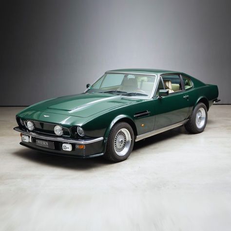 The Aston Martin V8 Vantage appeared in February 1977 as a performance-enhanced version of the V8. Externally, it was recognisable by deep front skirts, a clad radiator grille with recessed auxiliary headlights, widened wheel arches and a spoiler integrated into the tailgate. Optimised engines up to the X-Pack specification from 1986 offered outputs of up to 432 hp and made the car the fastest production vehicle of its time! Aston Martin Vintage Cars, Aston Martin V8 Vantage 1977, Old Aston Martin, Aston Martin Volante, Aston Martin Car, Classic Aston Martin, Austin Martin, Aston Martin V8 Vantage, Classic Road Bike