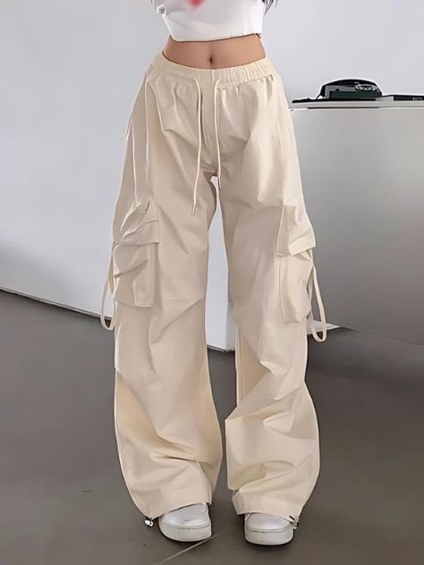 The plain baggy pants is designed with cargo strapped pockets. It also has adjustable strings for personalized fit, comfort and easy movement. Flutter free pants Drawstring waist and bottom ensuring a comfortable fit Fits true to size Cargo For Women, Drawstring Cargo Pants Outfit, Baggy Cargo Pants Outfit Woman, Bagy Pants, Baggy Pant Outfit, Aesthetic Baggy Clothes, Korean Baggy Pants, Streetwear Bottoms, Aesthetic Bottoms