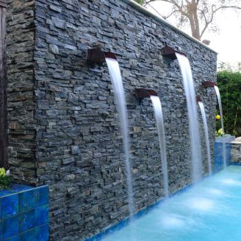 Custom Pool Water Features | Waterfalls, Gushers, Jets | Platinum Pools Swimming Pool Waterfall, Outdoor Wall Fountains, Water Fountain Design, Water Feature Wall, Swimming Pool Architecture, Pool Water Features, Pool Fountain, Backyard Water Feature, Swimming Pool Water