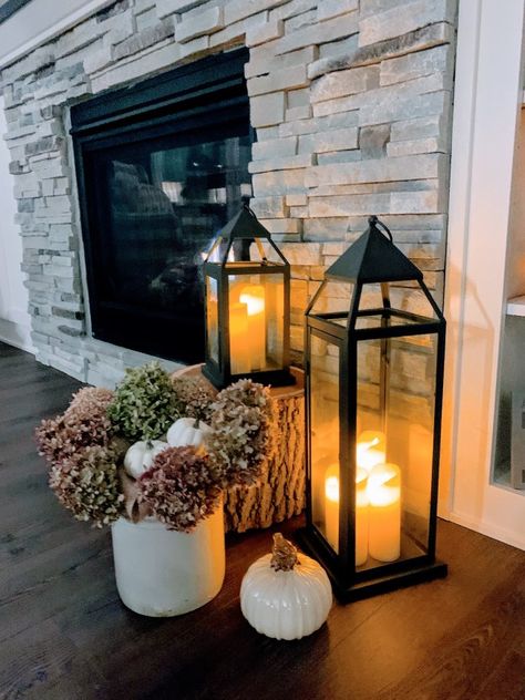 Living Room Lantern Decor, Fall Fireplace Decor With Lanterns, Lantern Entryway Decor, Lantern By Fireplace Decor, Lanterns By Fireplace, Floor Fireplace Decor, Latern Ideas For Home, Large Lantern Decor Ideas Fireplace, Candle Lanterns Decor Ideas Living Room