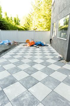 Checkerboard Pavers Around Pool, Tiled Backyard Patio, Black And White Pavers Outdoor Spaces, Backyard Square Pavers, Paver Patio Off Screened In Porch, Cement Squares In Backyard, 24x24 Concrete Paver Patio Ideas, Pavers For Backyard Patio, Tiling Over Concrete Patio