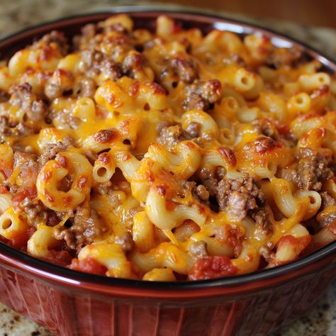 🍔✨ Try our comforting Hamburger Casserole for a hearty meal! 🍽️ #ComfortFood #FamilyDinner HAMBURGER CASSEROLE Ingredients: Ground beef (1 lb) Onion (1, diced) Garlic (2 cloves, minced) Tomato sauce (2 cups) Elbow macaroni (2 cups, cooked) Cheddar cheese (2 cups, shredded) Salt (1 tsp) Pepper (1/2 tsp) Olive oil (2 tbsp) Instructions: Preheat oven to 350°F (175°C). In a skillet, heat olive oil and sauté onion and garlic until soft. Add ground beef, cook until browned. Drain excess fat. St... Minced Beef, Hamburger Casserole, African Cooking, Hearty Meal, Elbow Macaroni, Comfort Dishes, Trending Recipes, Health Dinner Recipes, Hearty Meals