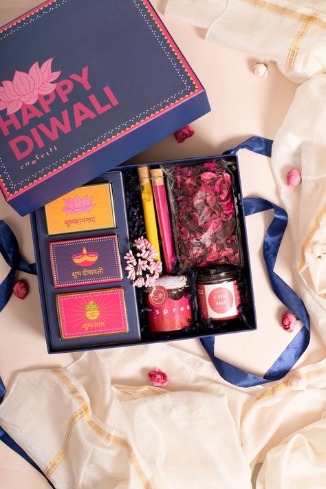 This Box Includes: Dry Fruits Blend 100 g Seeds and Berries Mix 100 g Ferrero Rocher x 4, 50 g Rangoli Test Tubes x 2 Spread It Strawberry Spared 40 g Rose Scented Candle ( Burn Time - 36 hours) Free handwritten greeting card of your choice  Reusable Confetti Gift box  Mention your customization requirement while check Diwali Gifts Ideas Hampers, Diwali Hampers Baskets Ideas, Indian Gift Basket Ideas, Diwali Chocolate Packing Ideas, Home Decor Gift Basket Ideas, Candle Hamper Gift Ideas, Diwali Corporate Gift Ideas, Corporate Diwali Hampers, Diwali Gift Packing Ideas