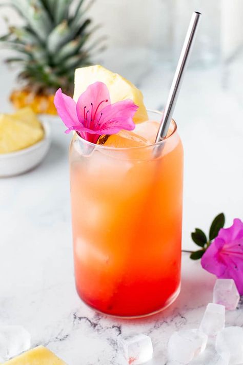 My go-to drink for this spring and summer is this Pineapple Orange Rum Punch. Transcend yourself to the tropical islands even when sipping on this drink in your kitchen. Tropical Fruit Cocktail, Orange Themed Cocktails, Tropical Cocktail Aesthetic, Pink And Orange Drink, Pineapple Summer Drinks, Tropical Food For Party, End Of Summer Cocktails, Easy Tropical Cocktails, Refreshing Cocktail Recipes