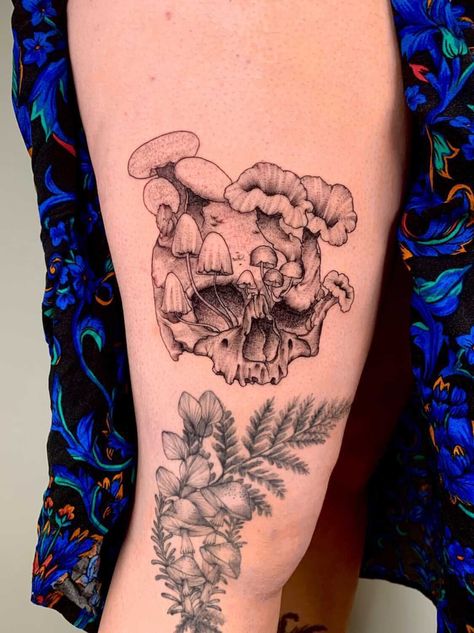 tattoo of a skull with multiple types of mushrooms growing out of it on right thigh above tattoo of ferns and mushrooms Mushroom Skull Tattoo Ideas, Skeleton Mushroom Tattoo, Skull Tattoo With Mushrooms, Skull And Mushrooms Tattoo, Mushroom Skull Tattoo, Skull Mushroom Tattoo, Skull With Flowers Tattoo, Skull Flower Tattoo, Pretty Skull Tattoos