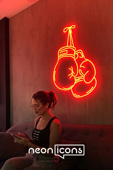 a neon sign designed after a set of boxing gloves. The colour of the neon sign is red and there is a female model sitting in front of it Boxing Neon Sign, Neon Room Decor Ideas, Graphic Designer Desk, Neon Line Art, Neon Room Decor, Neon Ideas, Neon Icons, Cool Neon Signs, Neon Light Art