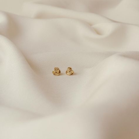 Knots are beautiful and meaningful symbols to represent unity and love. Our Love Knot Studs are timeless, classy, and powerfully symbolic. They'll make the perfect gift or everyday accessory. • Material: High-Quality Solid 925 Sterling Silver• Finish: Sterling Silver ∙ 18K Gold• Featuring 7mm Knot Stud Earrings SKU: RR-ER153 #Embracing #Art #Beauty #Minimalist #Jewelry #Exploring #Simplicity #and #of #The #Elegance #StatementJewelry #the Basic Earrings Studs, Small Gold Tops Designs, Dainty Stud Earrings, Gold Small Earrings Studs, Gold Earrings Studs Daily Wear, Gold Tops Earrings, Small Earrings Gold, Gold Knot Earrings, Meaningful Symbols