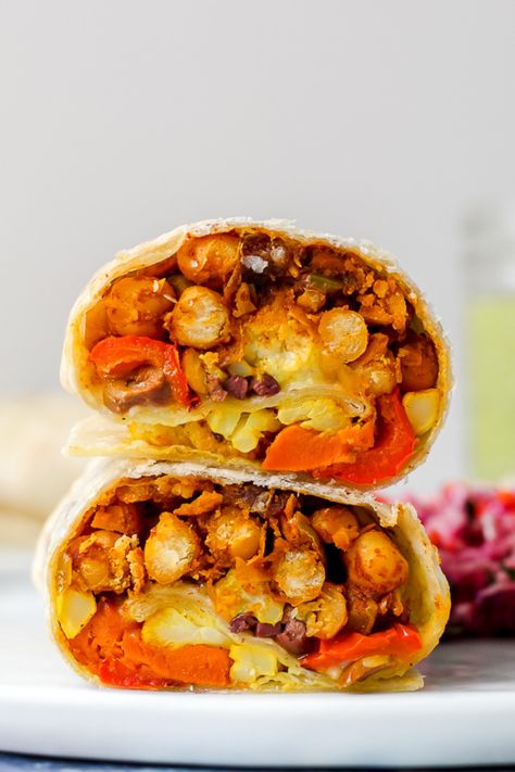 Moroccan chickpea burritos feature Moroccan-spiced chickpeas, turmeric-roasted cauliflower, roasted sweet potatoes, and peppers, feta, and olives. The dipping sauce is a tahini, lemon, and herb sauce- it's a delicious vegetarian dinner that is nutrient-rich and super flavourful! Green Tahini Sauce, Chickpeas Roasted, Green Tahini, Moroccan Chickpea, Moroccan Vegetables, Spiced Chickpeas, Roasted Vegetable, Weekend Meals, Savory Vegan