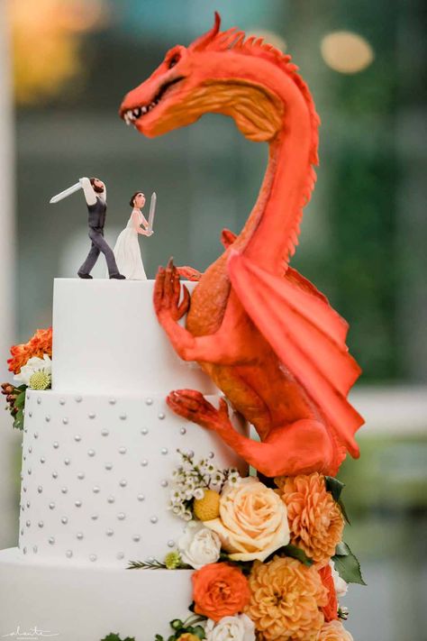 Orange dragon fantasy wedding cake with peach and orange flowers at Chihuly Glass House | Flora Nova Design Seattle Dragon Age Wedding, Dragon Wedding Cake Topper, Princess Bride Wedding Cake, Fantasy Wedding Cake Ideas, Fantasy Wedding Cake Topper, Dragon Wedding Decor, Mystical Wedding Cake, Pokémon Wedding Cake, Wedding Ideas Cottagecore