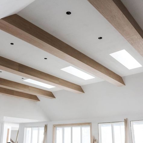 We love how these wooden beams turned out..The perfect way to fill out 14ft tall ceilings! Modern Beamed Ceiling, Modern Wooden Beams Ceiling, Beams On Textured Ceiling, Ceiling Beams Basement, Light Beams Ceiling, Wooden Beams Flat Ceiling, Wooden Beams Lighting, Slanted Ceiling Wood Beams, Wrapped Ceiling Beams