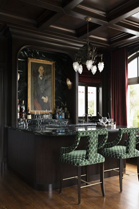 Kelly Ferm Home | Euro Lounge 1 As seen in Andrew Martin Interior Design Review one of our favorite rooms. The perfect place to retreat to and have a drink #bar #homebar #librarybar #darkwalls #darkpanelledwalls #drapery #reddrapery #barstools #fluttedbar #greenmarble #custom #customhome #clubseating #seating #lounge #barlounge #interiors #interiordesign #design #designers #kellyferm #Kellyfermhome #homewithstyle #Onlyprettythings #greenbarstools #cofferedceiling #ceiling #ceilingmillwork Moody Lounge, Moody Bar, Art Nouveau Bar, Counter Backsplash, Bar Lounge Room, Emerald Fabric, Marble Cocktail Table, Bubbly Bar, Bar Art