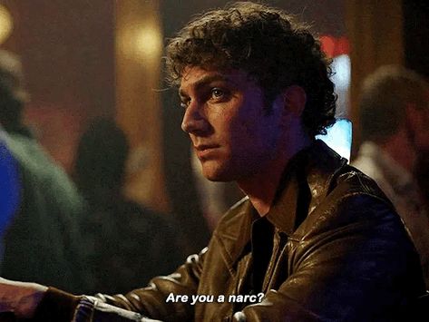 A young man sits at the bar in near profile view, facing left. He has lightly tanned skin, green eyes and curly Black hair. He wears a brown leather jacket. Subtitles read: “are you a narc?” Luke Brandon Field, Young Daniel Molloy, Luke Brandon, Iwtv Amc, Daniel Molloy, Vampire Shows, Vampire Chronicles, The Vampire Chronicles, Anne Rice