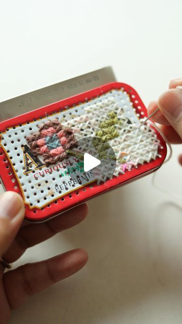 Arounna Khounnoraj on Instagram: "I wanted to reuse this altoid tin to hold my sewing notions.  There are so many ways you can decorate it and I didn’t want to stick paper or fabric to the surface.  John @bookhou_john suggested I drill holes to cross stitch, it was a crazy idea he knew I would try.  It was very satisfying to drill and sew and I really love the end result🤩🧡 
let me know what you think" How To Decorate Altoid Tins, Unusual Embroidery Ideas, Reuse Altoid Tins Ideas, Altoid Tin Ideas Diy, Altoid Tin Crafts, Altoids Box Ideas, Altoid Tin Ideas, Mint Tin Crafts, Tin Ideas